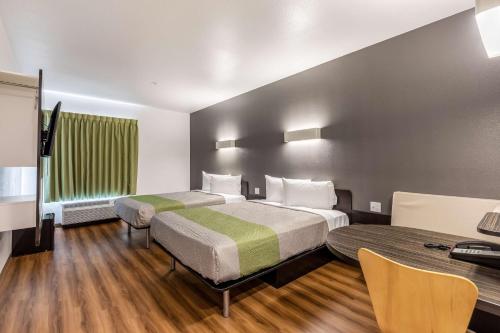 a hotel room with two beds and a desk at Motel 6-Las Vegas, NV - Motor Speedway in Las Vegas