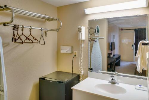 a bathroom with a sink and a green refrigerator at Motel 75 Monroe in Monroe