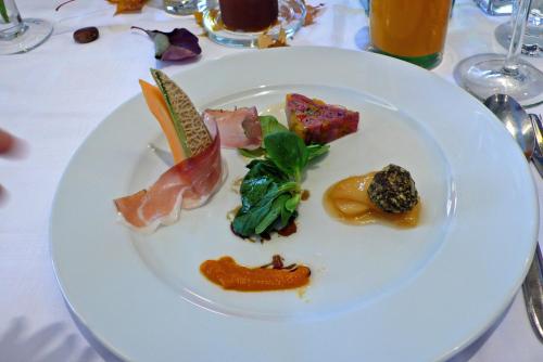 a white plate with food on a table at Gasthof-Hotel Jaritz in Semriach