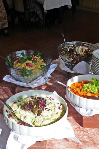 a table with three bowls of food on it at Gasthof-Hotel Jaritz in Semriach