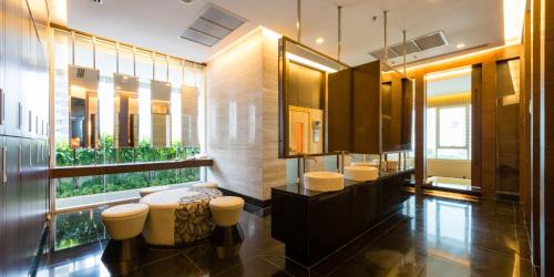 a bathroom with three stools and a large window at Jasmine Grande Residence in Bangkok