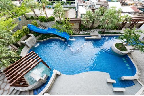 an aerial view of a swimming pool with a water slide at Jasmine Grande Residence in Bangkok