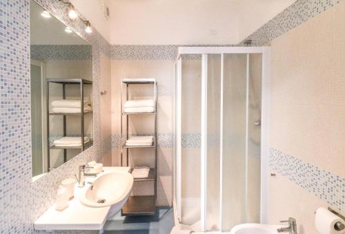 a bathroom with a sink and a shower at Hotel Jesulum in Lido di Jesolo