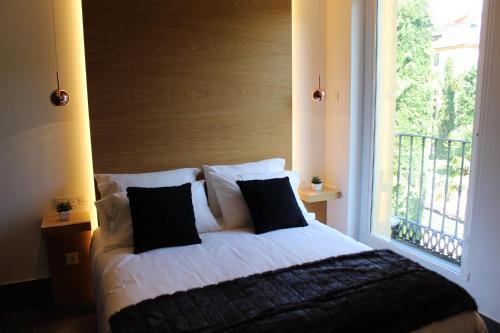 a bed in a room with a large window at Salamanca Suites Libertad in Salamanca