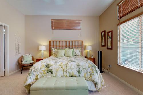 a bedroom with a bed and a chair and a window at Lovely La Quinta Permit# 66318 in La Quinta