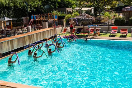 a group of people playing in a swimming pool at Camping Parc Mogador in Sanary-sur-Mer