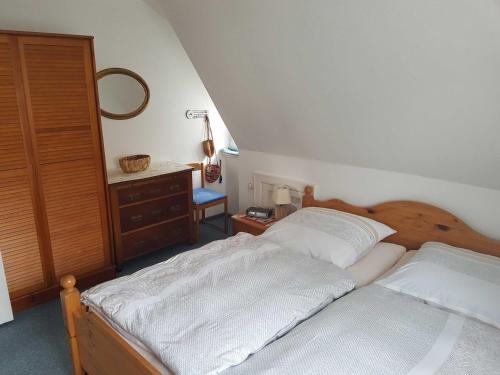 a bedroom with two beds and a dresser at Horn Ingrid in Neustadt in Holstein