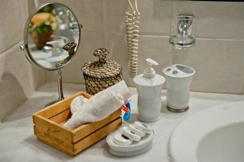 a bathroom counter with a sink and a mirror at Four Seasons Hotel in Athens