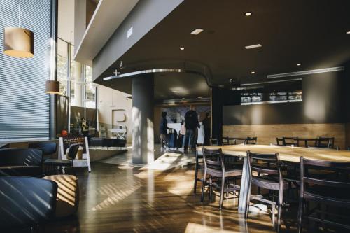 a restaurant with a table and chairs and people at B Hotel in Barcelona