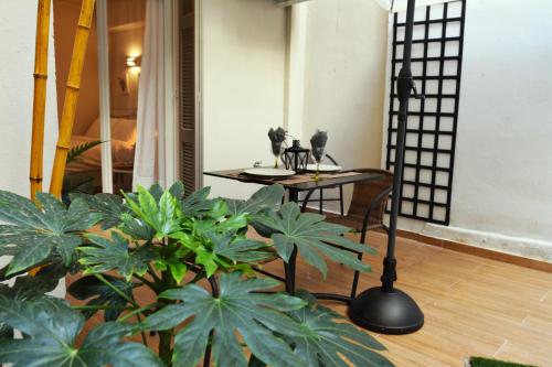 a room with a table and some plants and a table at Studio Posh with garden in Kolonaki in Athens