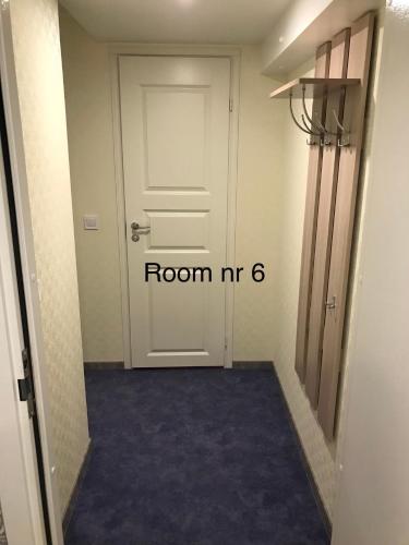a hallway with a door with room written on it at Liivalaia 40 cozy kitchen studio in Tallinn