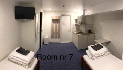 a small room with two beds and a kitchen at Liivalaia 40 cozy kitchen studio in Tallinn