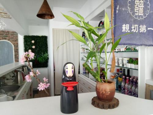 a kitchen counter with a vase and a plant at 小時公館城西 in Yuli