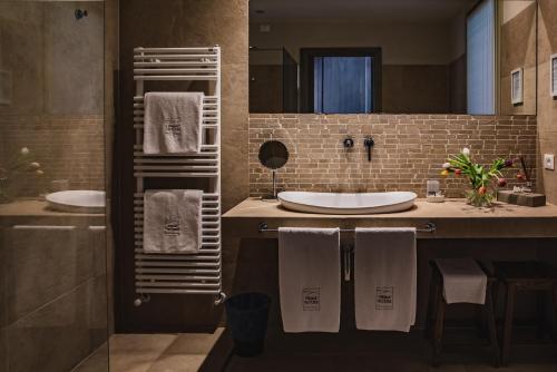 a bathroom with two sinks and a large mirror at Prime Alture Wine Resort in Casteggio