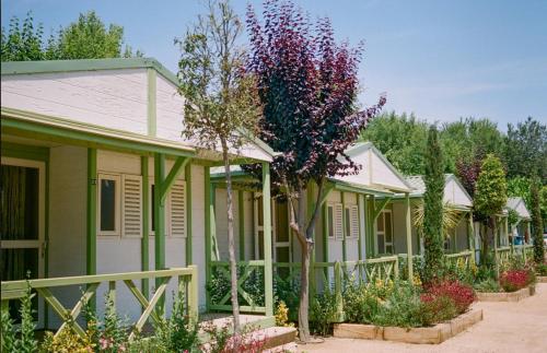 a row of houses with flowers and trees at Camping Sènia Caballo de Mar in Pineda de Mar