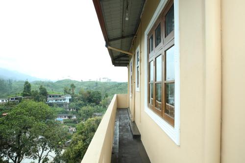 a balcony with a view of a city at Mount View Bungalow in Hatton