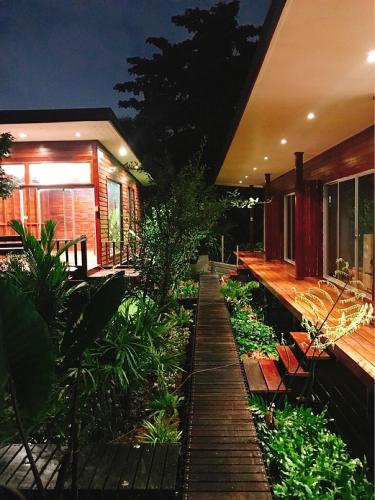 a garden in front of a house at night at 88 Homestay in Bang Chak