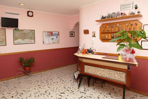 a waiting room with a desk and a potted plant at Hotel Linda in Sorrento