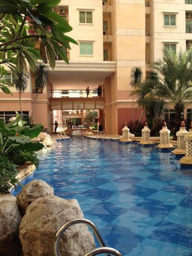 a large swimming pool in the middle of a building at Ravarine Suite Apartment in Jakarta