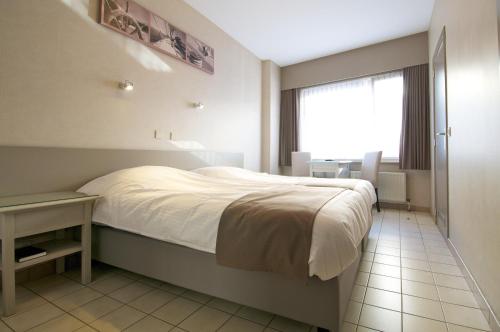 Postel nebo postele na pokoji v ubytování Hotel De Golf