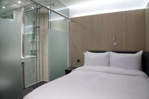 a bedroom with a bed and a glass shower at The Z Hotel Liverpool in Liverpool