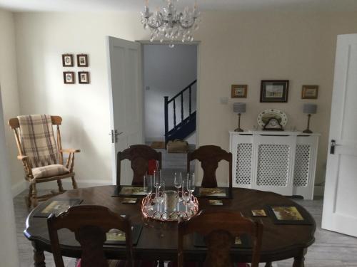 a dining room with a table and chairs and a chandelier at The Stone House, Multyfarnham in Multyfarnham