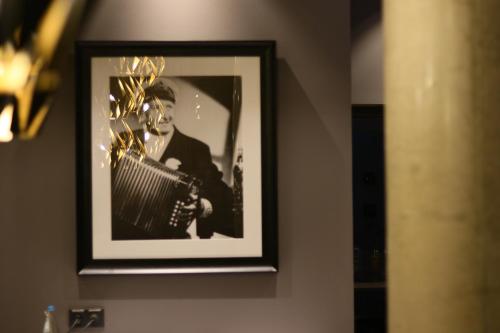 a black and white picture of a man holding a bat at HARBR. hotel Konstanz in Konstanz