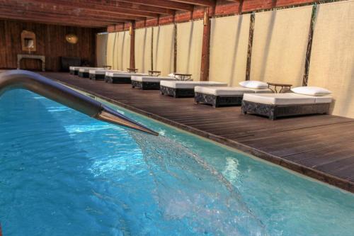 a swimming pool with chaise lounge chairs and a pool at Masseria & Spa LuciaGiovanni in Lecce