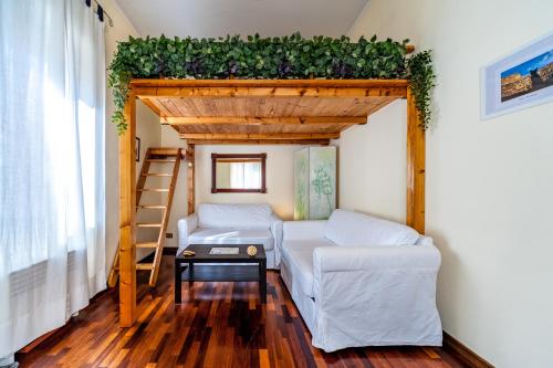 a tiny house with a bed and a ladder at Gallo's Holidays St Peter in Rome