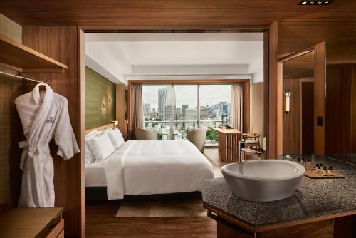 a bedroom with a bed and a bathroom with a tub at The Prince Park Tower Tokyo - Preferred Hotels & Resorts, LVX Collection in Tokyo