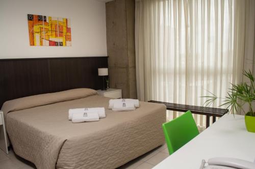A bed or beds in a room at Torre Potosi Departamentos