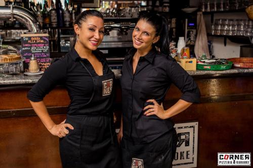 two women standing in front of a bar at Hotel Youri Il Magnifico in Genova