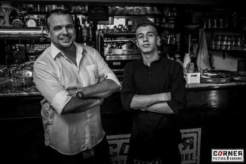 two men standing in a bar with their arms crossed at Hotel Youri Il Magnifico in Genova