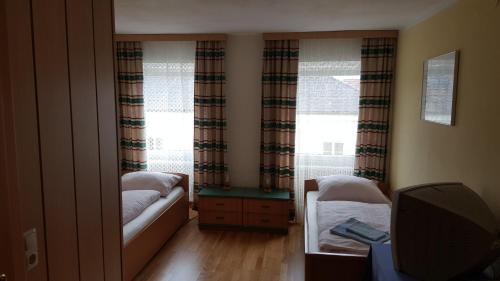 a small bedroom with a bed and a window at Stiftsgasthof Hochburg in Hochburg-Ach