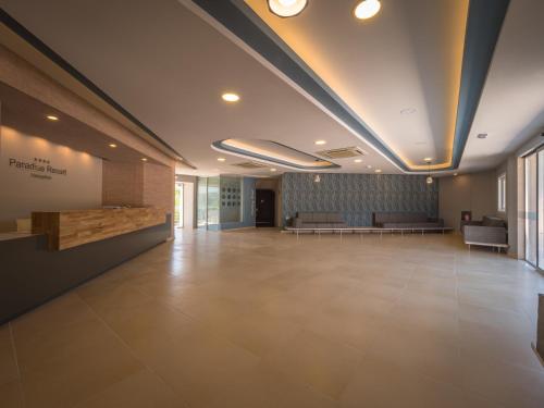 an empty lobby with couches and a waiting room at Paradise Resort in Finikounta