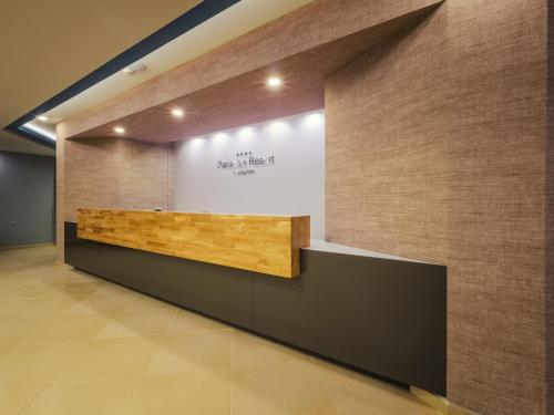 a lobby with a sign on a wall at Paradise Resort in Finikounta
