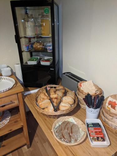 a table with some food on it with a refrigerator at Haus am Grasberg in Poppenhausen