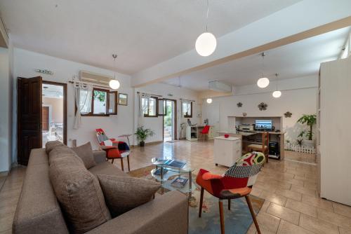 uma sala de estar com um sofá, cadeiras e uma mesa em Byron Hotel em Argostoli