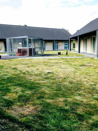 a house with a large yard in front of it at Hotel Fleur de Lys in Bailleul