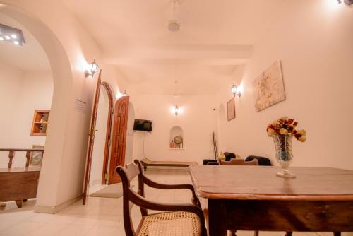 a dining room with a table and chairs at Muhsin Villa - Galle Fort in Galle