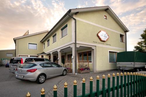 a building with a car parked in front of it at Biergasthof Riedberg in Ried im Innkreis