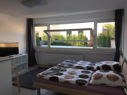 een slaapkamer met een bed en een groot raam bij Tina in Heiligenhaus