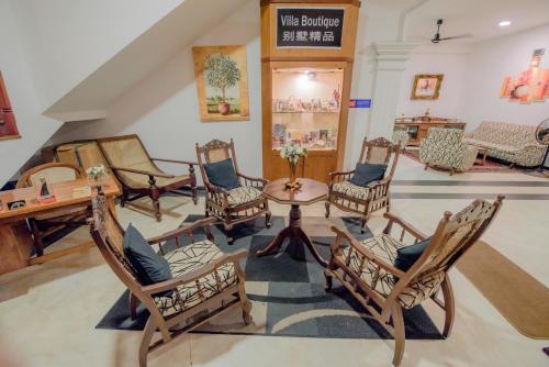 a group of chairs and a table in a room at Muhsin Villa - Galle Fort in Galle
