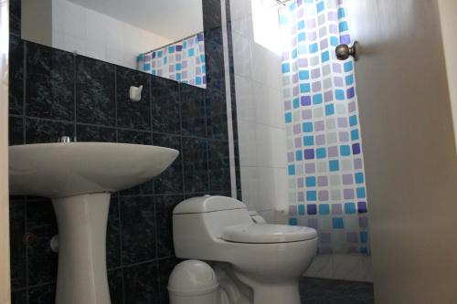 a bathroom with a toilet and a sink at La Almohada del Rey in Arequipa