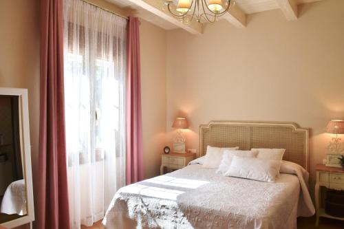 a bedroom with a bed and a large window at Villa Miranda in El Rompido