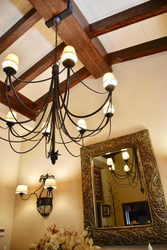 a chandelier in a room with a mirror at Villa Miranda in El Rompido