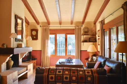 a living room with a couch and a fireplace at Villa Miranda in El Rompido