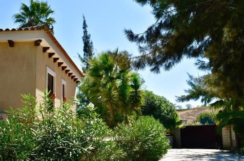 a house with a lot of trees next to a driveway at Villa Miranda in El Rompido