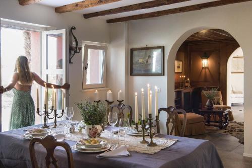 a woman standing in front of a table with candles at Panigai House in Aquiléia