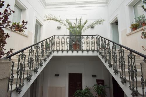 a staircase in a house with a plant at Palazzo di Fazio Suites in San Severo